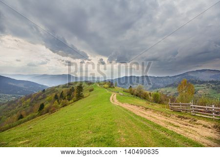 Trail in the countryside and mountains in the background. Carpathians