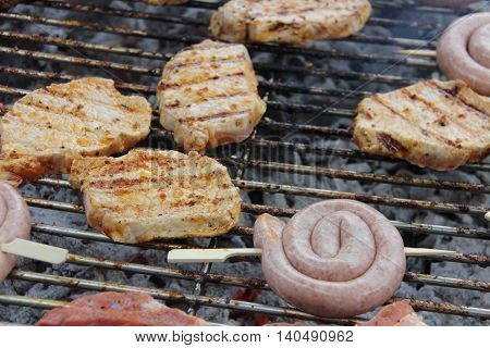Looking over a charcoal grill with grilled meat