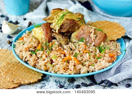 Traditional middle eastern or indian dish of rice (pilaf) cooked with meat and spices selective focus