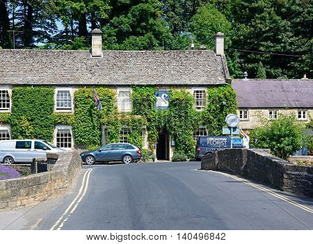 BIBURY, UNITED KINGDOM - JULY 20, 2016 - View across the road bridge towards The Swan Hotel Bibury Cotswolds Gloucestershire England UK Western Europe, July 20, 2016.