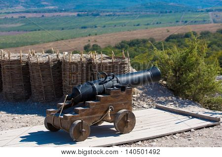 Historical artillery. Old cannon is fighting in a mountain area