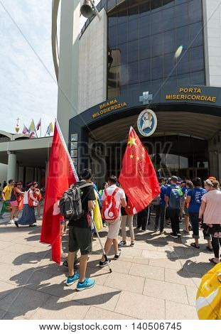 CRACOW POLAND - JULY 26 2016: World Youth Day 2016 - Pilgrims from China come across Door of Mercy in the Sanctuary of Divine Mercy in Lagiewniki. Cracow Poland
