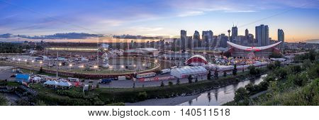 CALGARY, CANADA - JULY 8: Panoramic view of the the Calgary Stampede at sunset on July 8, 2016 in Calgary, Alberta. The Calgary Stampede is often called the greatest outdoor show on Earth.