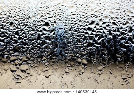 Moisture on glass from a cold day.