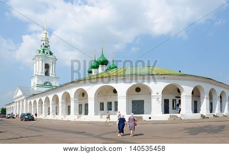 KOSTROMA RUSSIA - JULY 20 2016: Unidentified people visit famous Shopping (Red ranks) and Church of Our Saviour in ranks in Kostroma Golden Ring of Russia