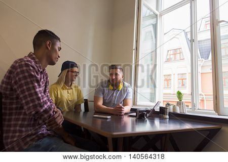 Photographer has conversation with clients. Photocamera and notebook - photographers tools or instruments to proove his proffesionalism - are prepared for photo session.