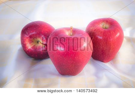 Red apples in the morning . Placed on brown cloth.