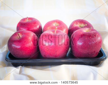 Red apples in the morning . Placed on brown cloth.