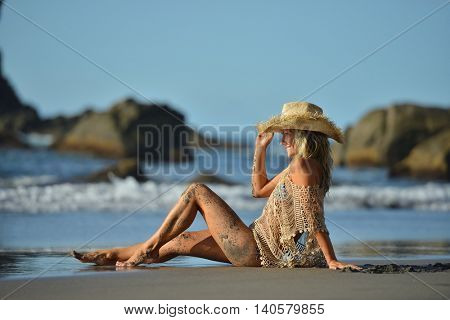 young woman relaxing on the beach in summer day