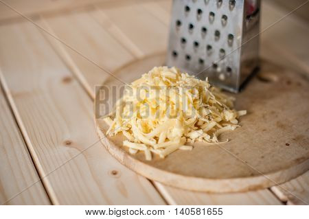 Grated Cheese On A Wooden Board