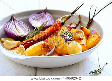 Roasted vegetables in a white plate. Vegeterian dish.