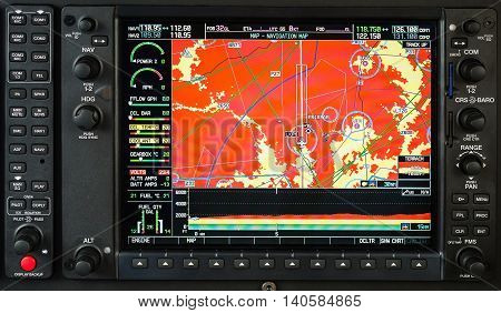 Airplane glass cockpit display G1000 with weather radar and engine gauges in small private airplane