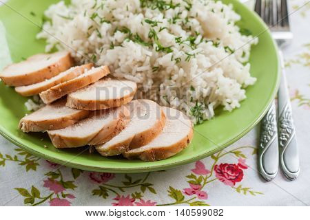 White Rice With Greens And Sliced Pieces Of Meat Grilled On A Green Plate