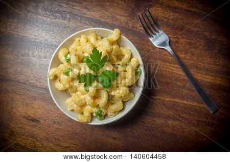 Delicious macaroni and cheddar cheese with parsley sprig