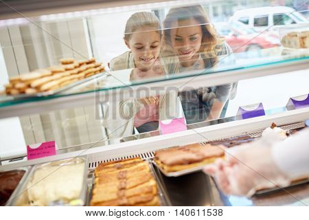Daughter and her mother choose sweets in beautiful candy store
