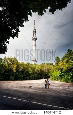 Two friends tourist looking at TV tower Kok-Tobe in Almaty Kazakhstan