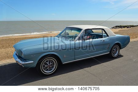 FELIXSTOWE, SUFFOLK, ENGLAND - MAY 01, 2016: Classic Blue Ford Mustang motor car parked on  Felixstowe seafront promenade.