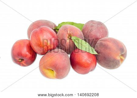 Several ripe fresh peaches and nectarines on a light background