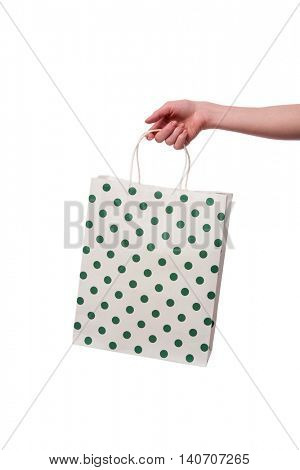 Hand holding giftbag isolated on white
