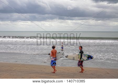 Bali,Indonesia-May 25,2010:Undentified group of surfer walking on the Kuta beach in the morning.Kuta Beach,Bali,Indonesia has one of the best surfing scenes in Asean.