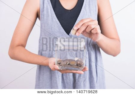 hands holding piggy bank show money coin in piggy bank on white background. business savings finance concept