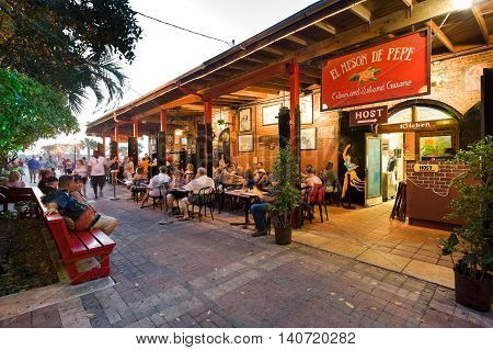 KEY WEST FLORIDA USA - MAY 03 2016: Tourists are eating and relaxing at a restaurant near Mallory Square in Key West in Florida.