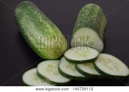Fresh Cucumber slices on a black background