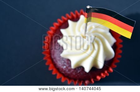 German National Day cupcake with german (black red and yellow) flag. The Day of German Unity. Focus on the flag.