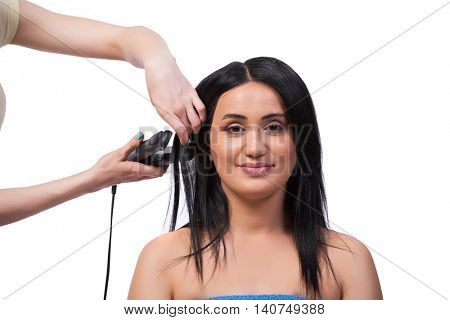 Young woman getting hair straightner isolated on white