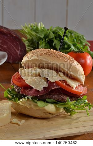 Hamburger with parmigano cheese and ingredients.