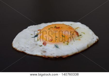 Chicken egg, salted and spiced fried egg.