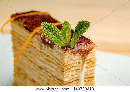 Dessert - Cake with chocoltae Icing and Fresh Mint. Sweet food calorie