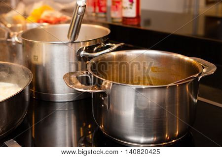 aluminium and metallic pans and cookware on kitchen