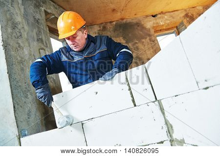 bricklayer at work with silicate brick