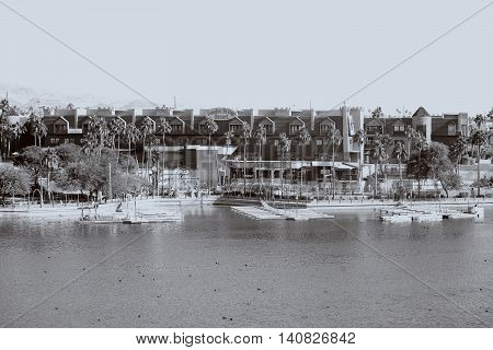 LAKE HAVASU CITY, UNITED STATES - DECEMBER 23: The shores of Lake Havasu at the London Bridge Resort with a boardwalk and jetties on December 23, 2015 in Lake Havasu City.