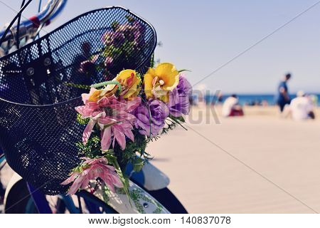 closeup of some bicycles ornamented with artificial flowers in the promenade of La Barceloneta beach, in Barcelona, Spain