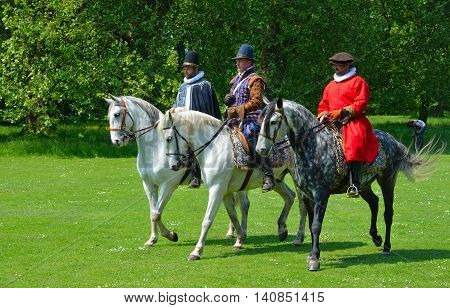 SAFFRON WALDEN, ESSEX, ENGLAND - JUNE 05, 2016: Three Grey horse  being  ridden by men wearing Elizabethan costumes.