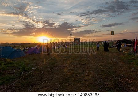 KRAKOW POLAND - JUL 31 2016 World Youth Day and the Catholic youth International Convention July 25-31. Adoration of the Eucharistic Jesus in the rear sectors of the youth on standby at sunrise.