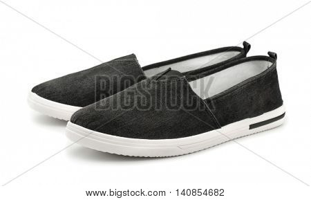 Pair of black canvas slip on casual shoes isolated on white