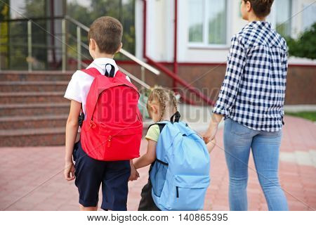 Mother taking children to school