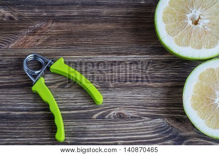 The concept of a healthy lifestyle. Pamela fruits and hand espander.