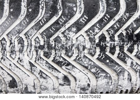 Old black tire. Tread with white paint