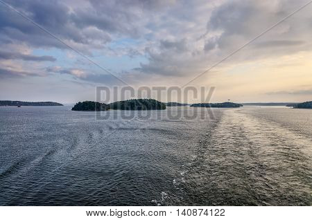 View to Sweden micro islands near Stokholm from boat, evening time
