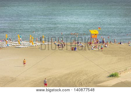 Mamaia Romania - July 18 2016: People resting on beach on in Mamaia Romania. Mamaia is the largest and best known resort on Romanian Riviera. It's situated on 8km long and 300m wide sandy land strip at the Black Sea.