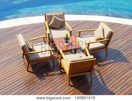 a table with chairs at the poolside restaurant