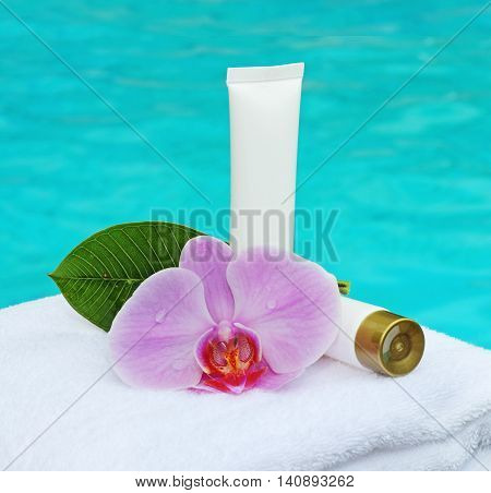 cosmetics for care. cosmetic bottles and orchid
