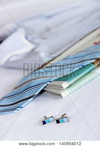 Men's classic shirts and newspaper on the bed