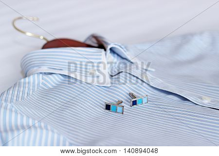 Men's classic shirts on the bed. Shallow depth of field
