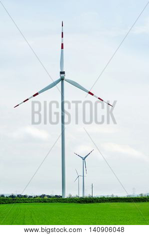 Wind turbine in field. Group of wind turbine. A windfarm or wind park is a group of wind turbines in the same location used to produce electricity.