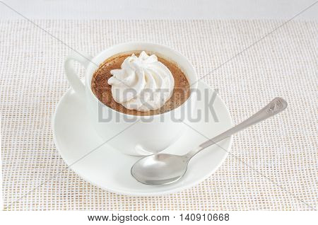 A cup of coffee and cake in a white bowl